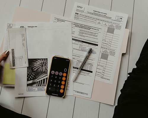 Picture of a calculator and documents on a table